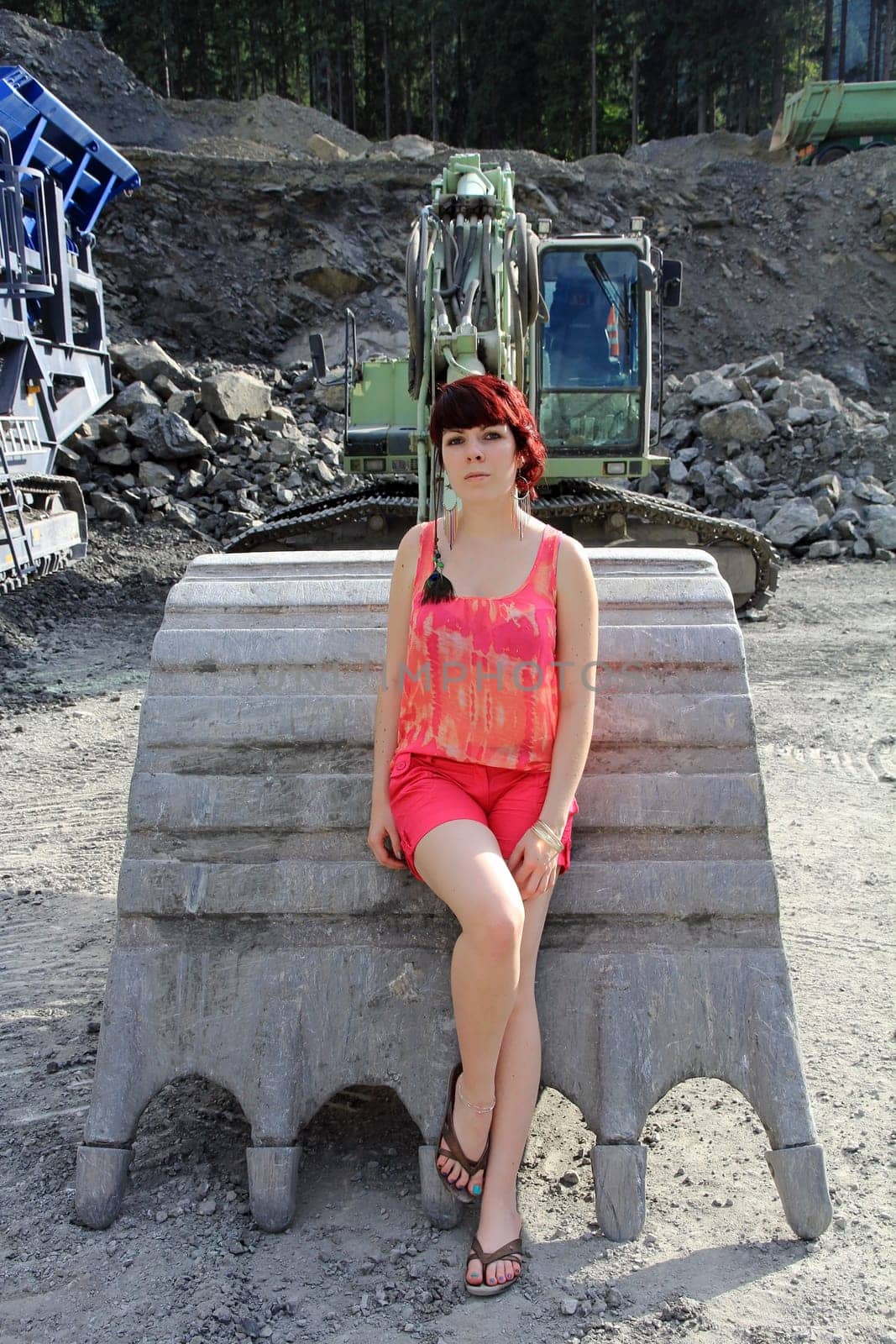 In front of the excavator bucket
