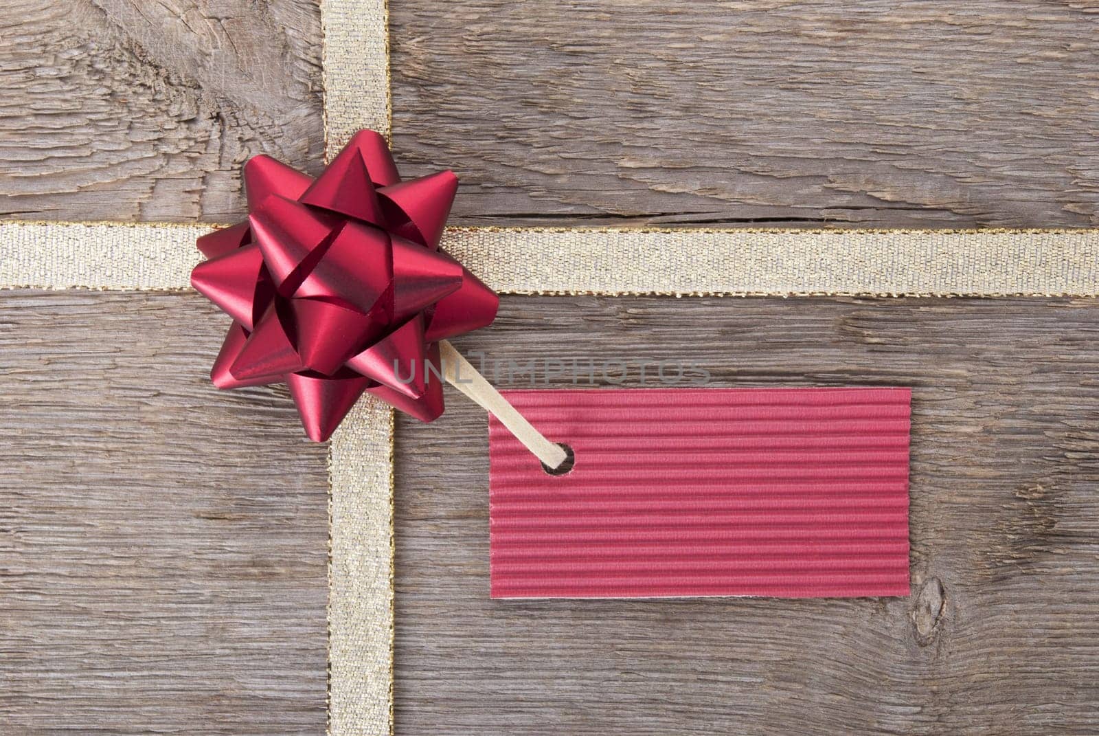 a red ticket with copy space hanging on a bow as gift background