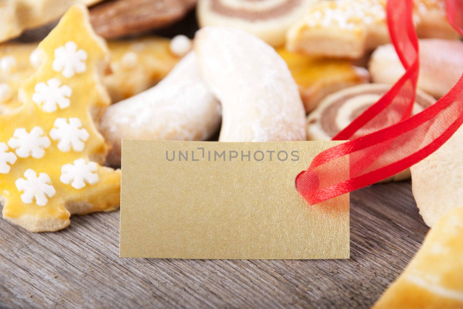 many christmas cookies as background with a golden label with copy space on it