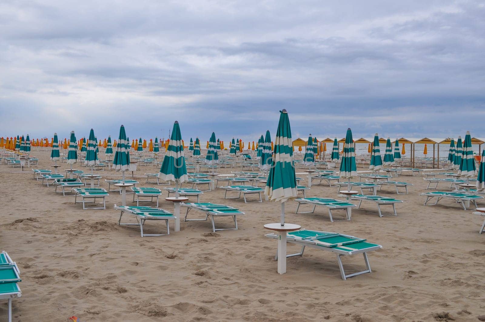 Shore beach with sun umbrella and deckchairs