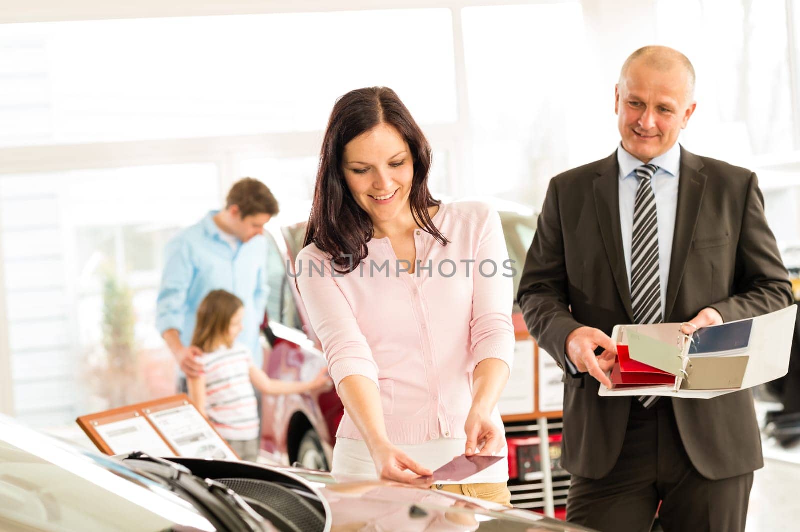 Young wife choosing the color of family car