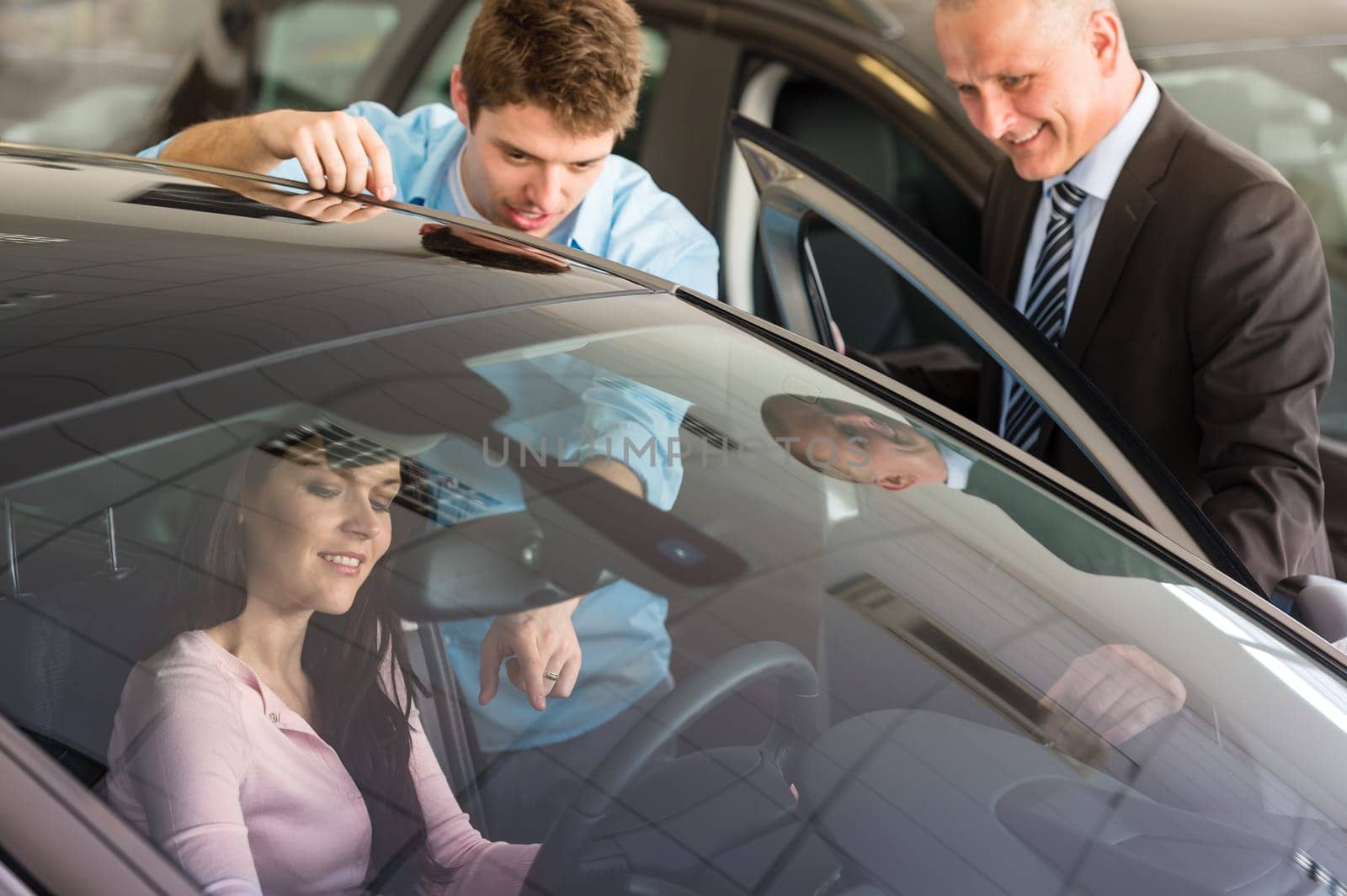 Young Caucasian couple choosing car