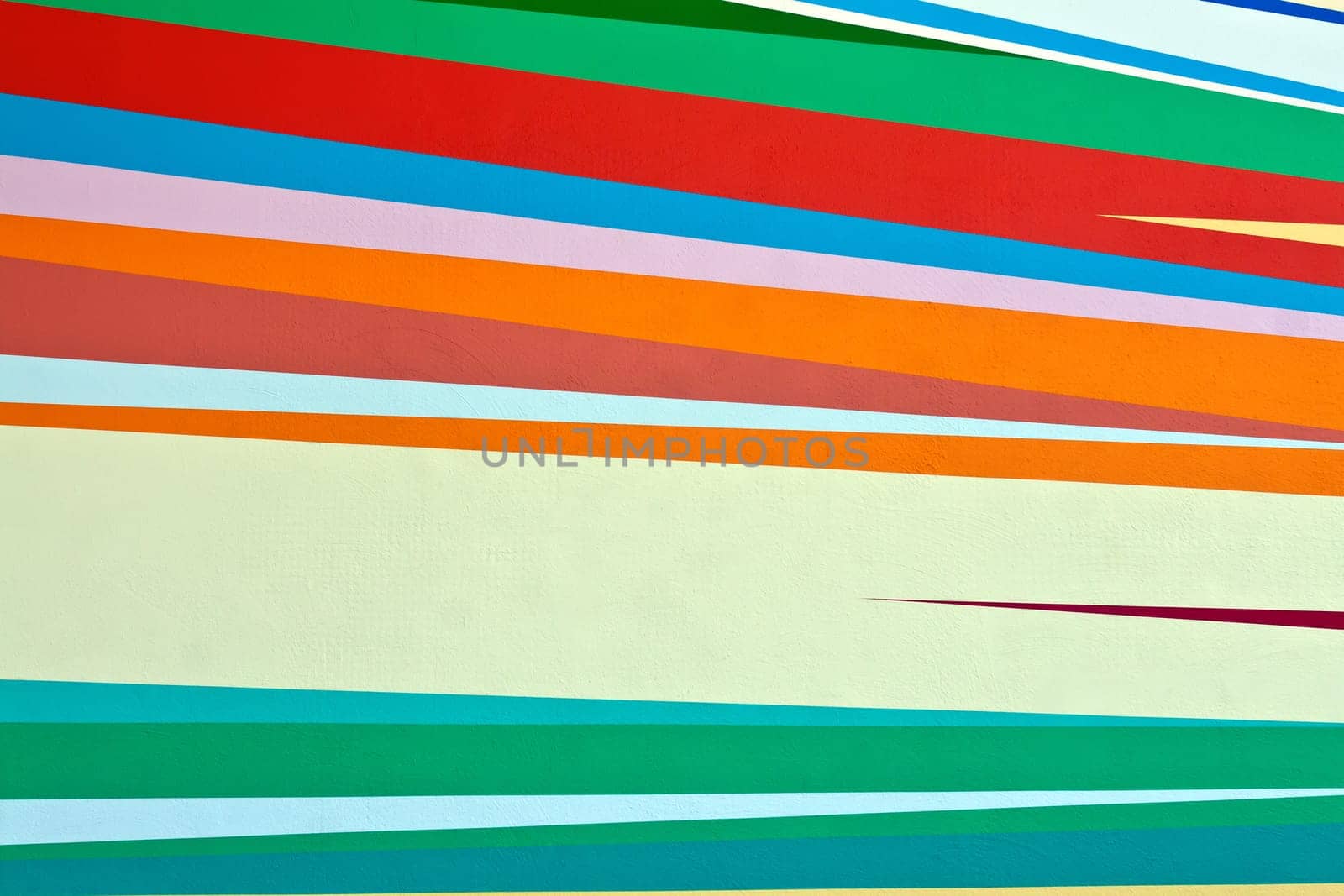 background of colored bands painted on the wall paint carnival