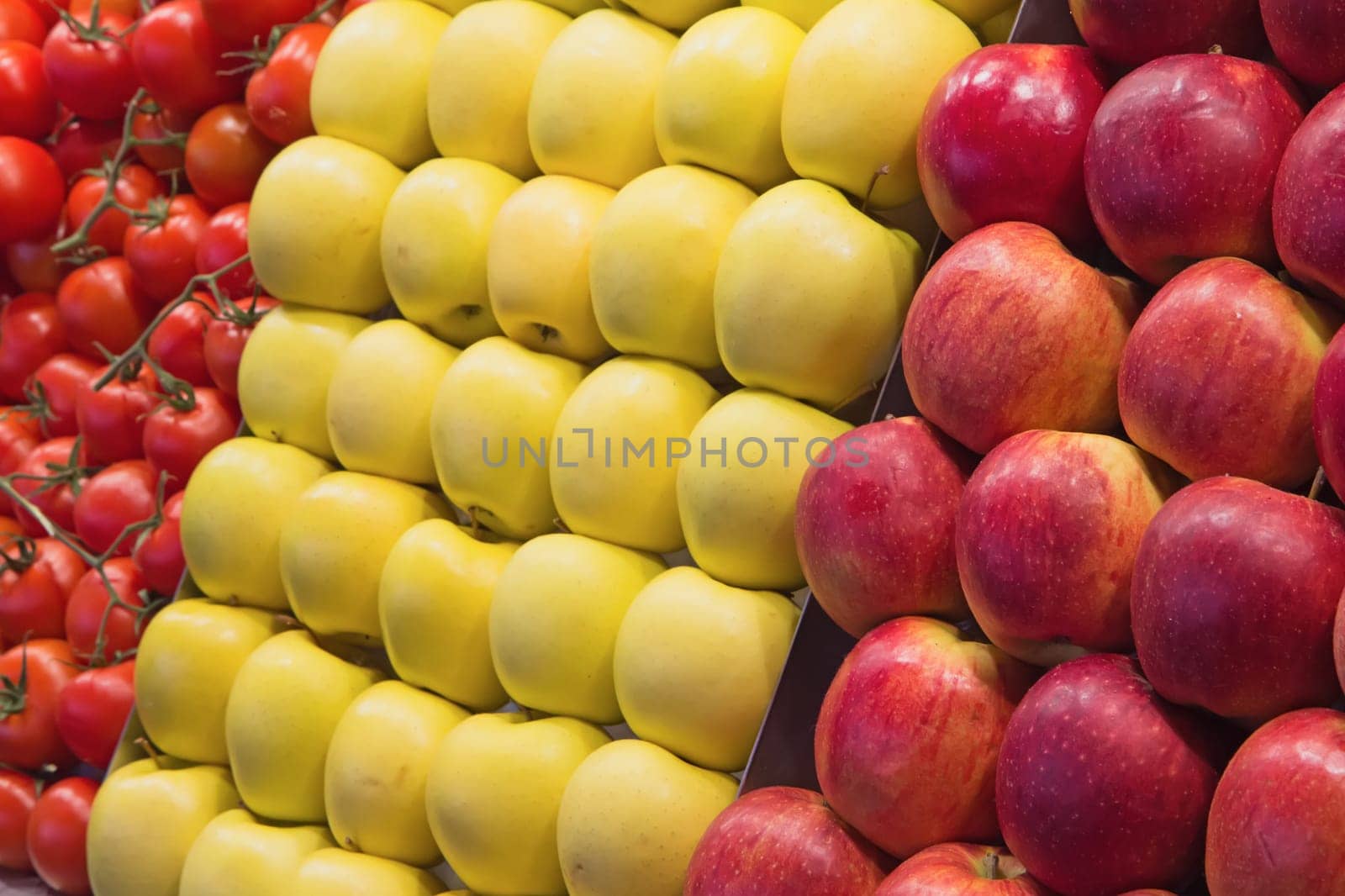 Red and yellow apples and tomatoes ready to sell on the market