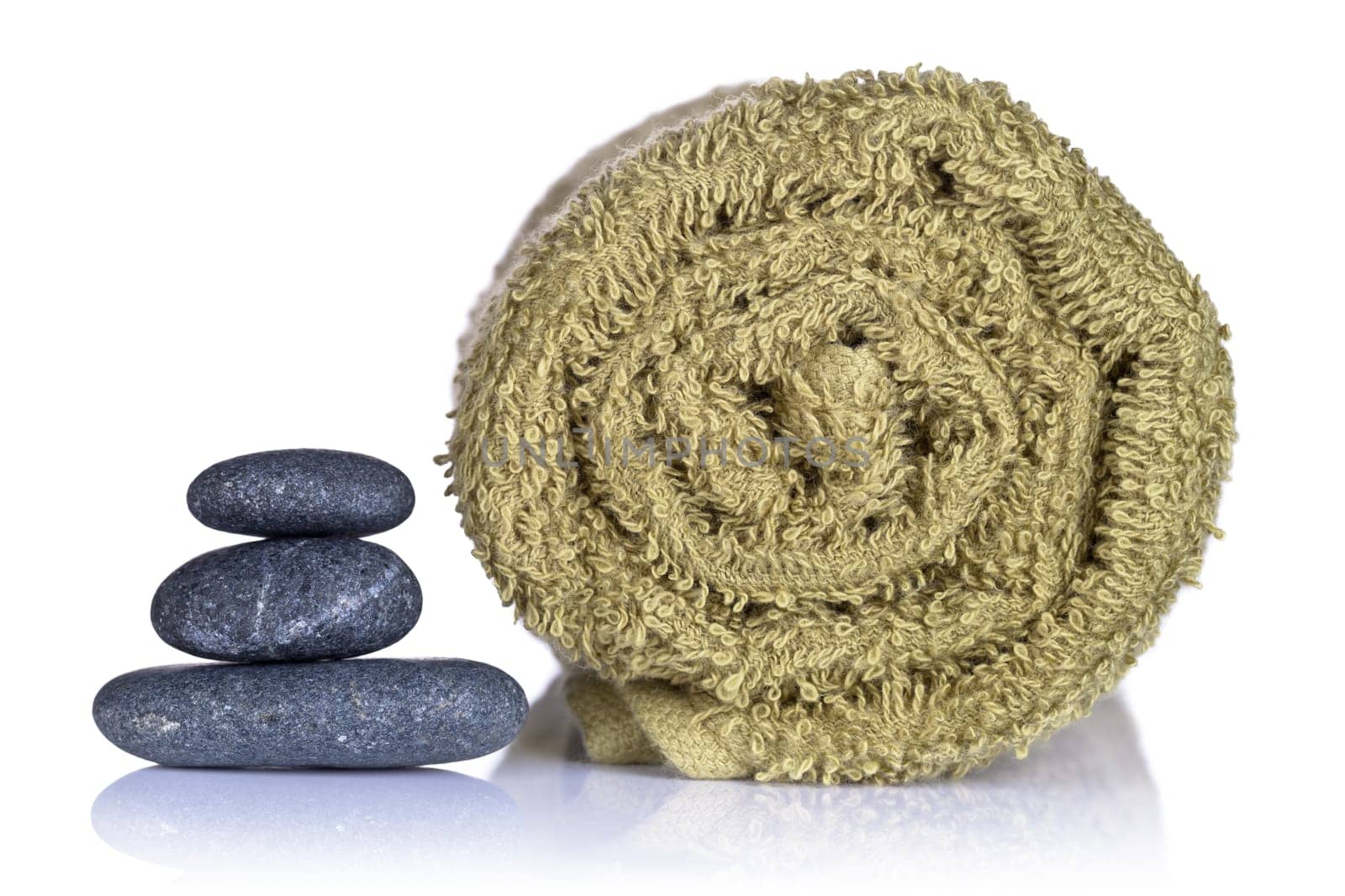 Spa stones and towel on white background. Spa concept. Macro shot