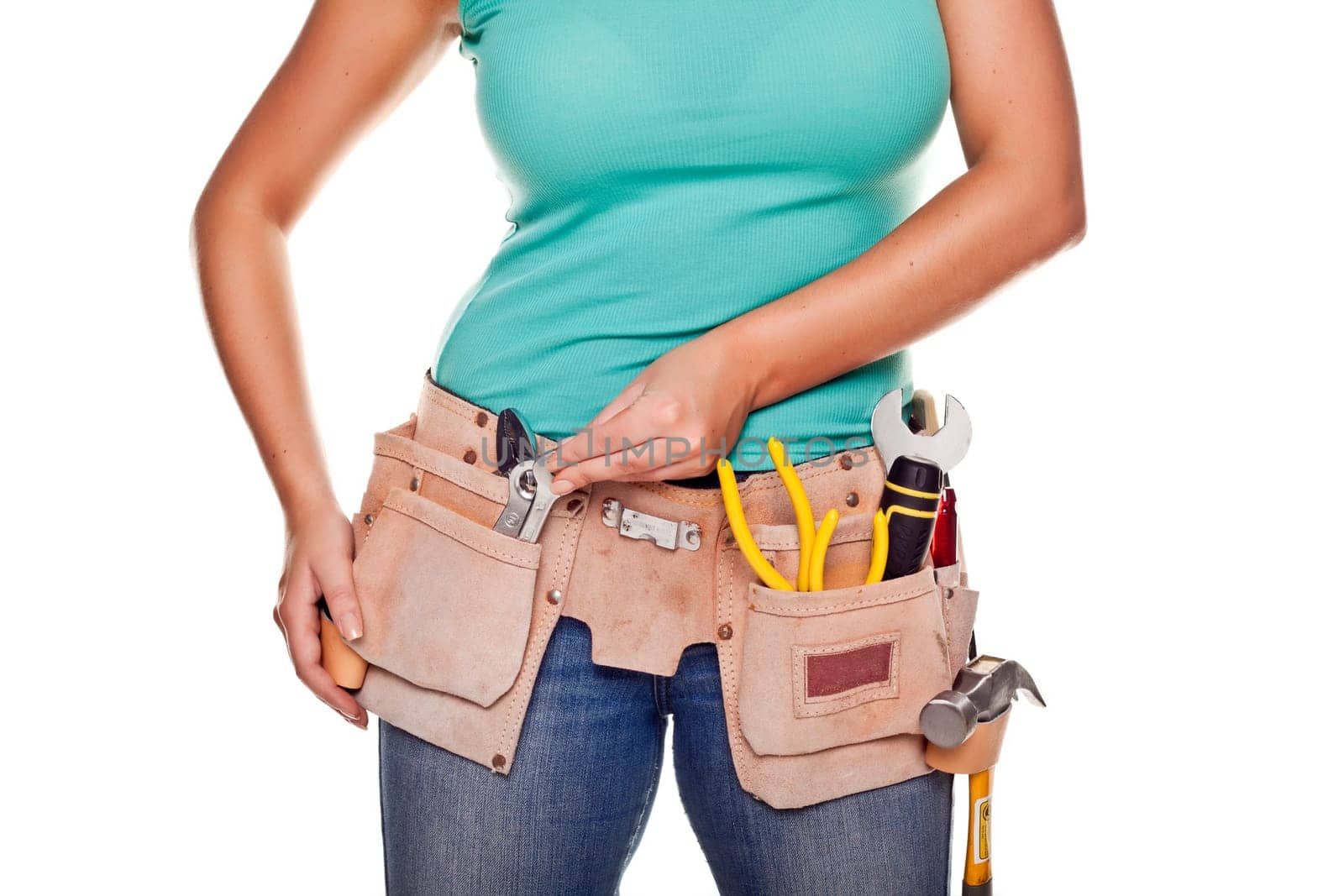 A woman wearing a DIY tool belt full of a variety of useful tools on a white background.