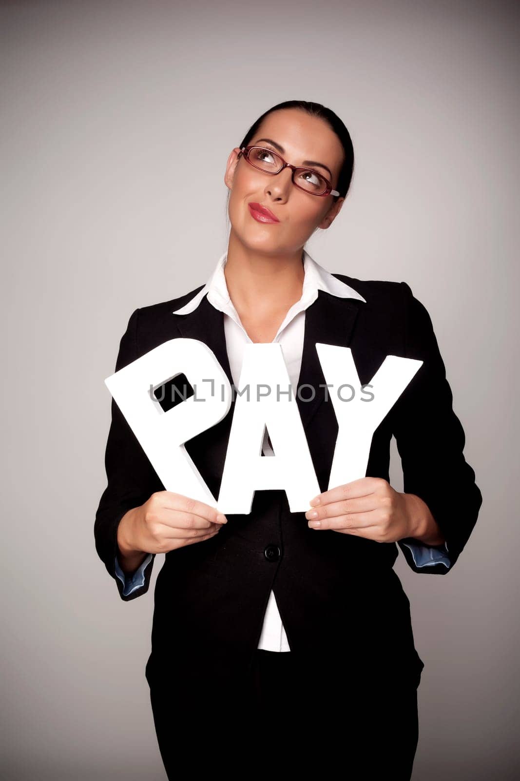 A income concept image of a woman holding letters that spell out the word pay demonstrating fare pay for woman.