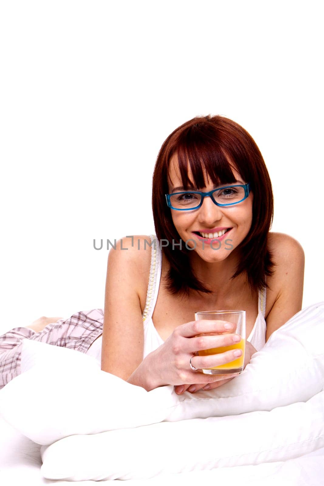 A young woman on her bed relaxing in the morning.