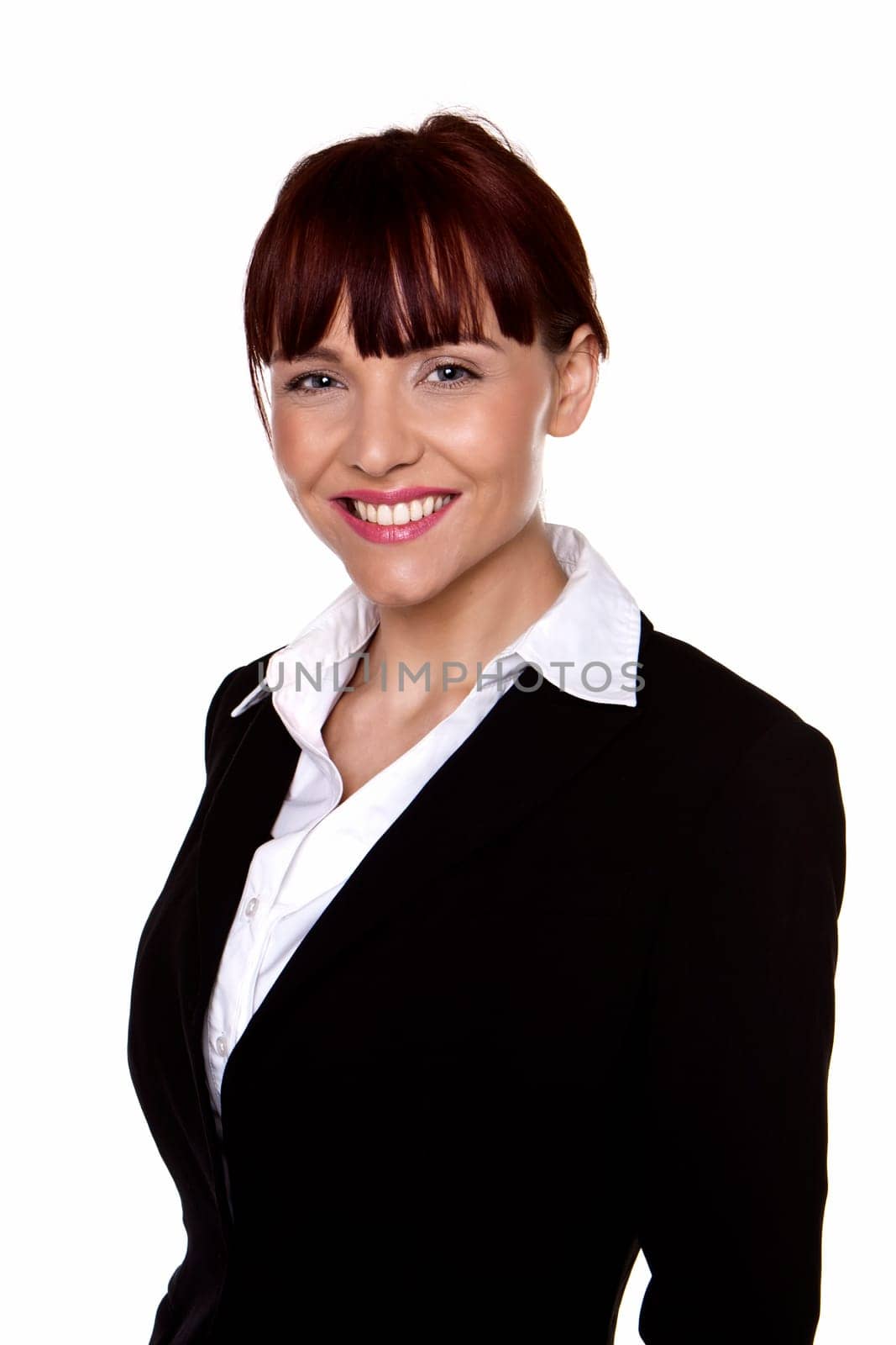 A portrait of a young confident business woman wearing a black business suit.