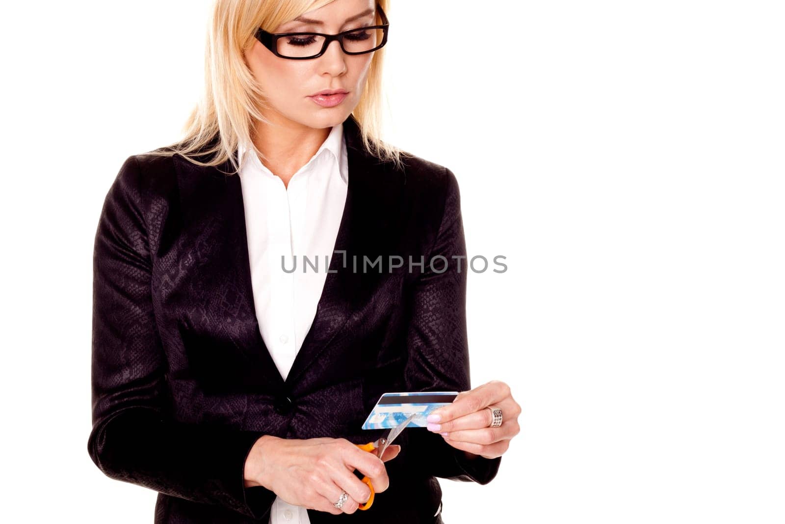 A young businesswoman is cutting up a bad credit card on a white background
