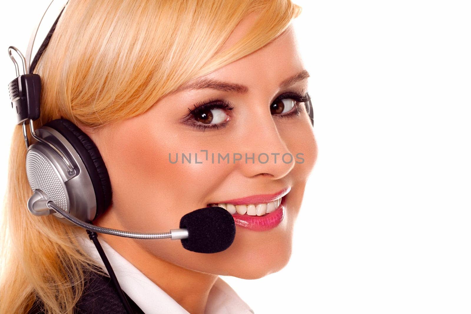 A beautiful young woman talking on a headset in a call centre
