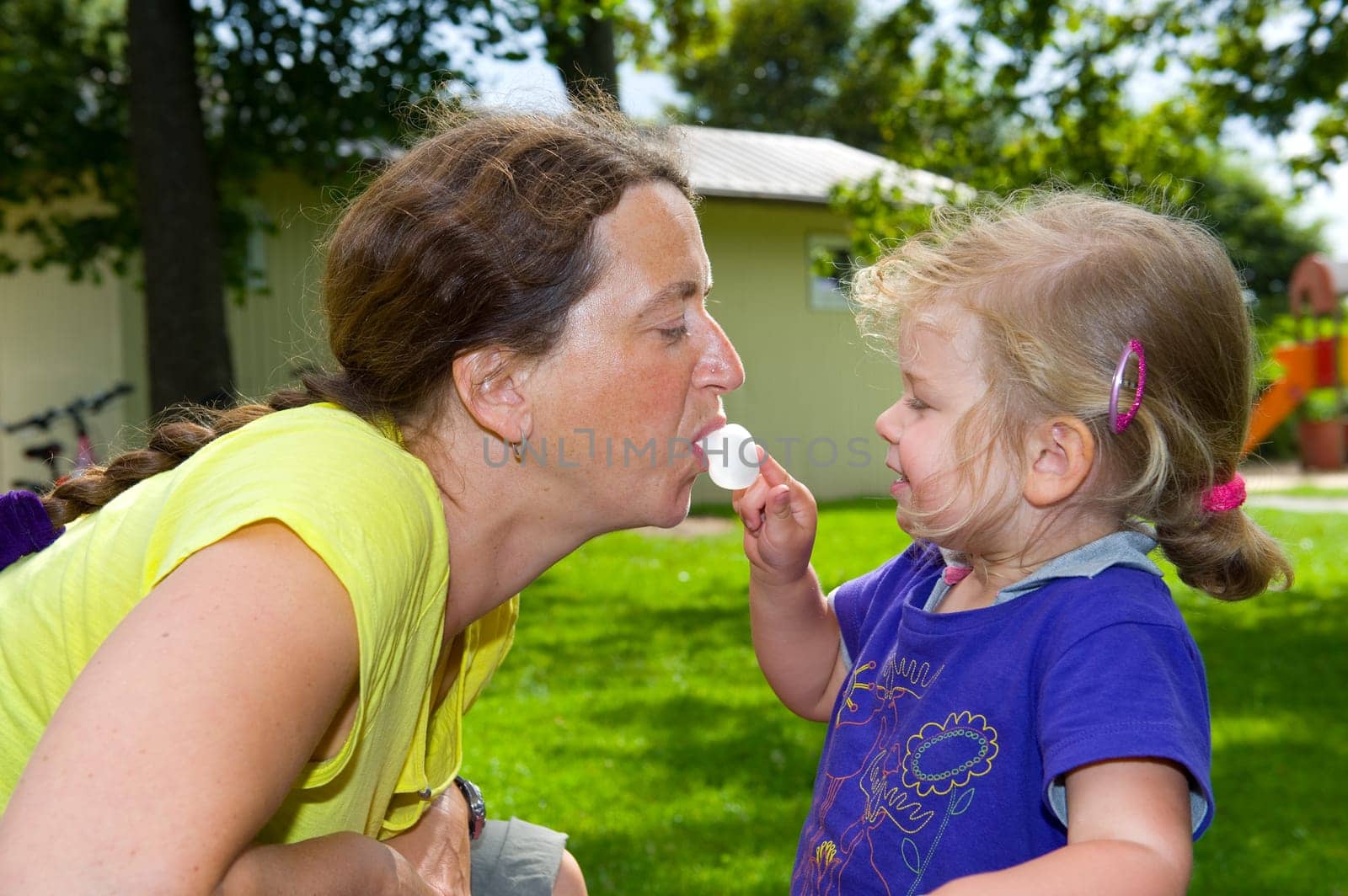 girl is playing with mothers bubblegum