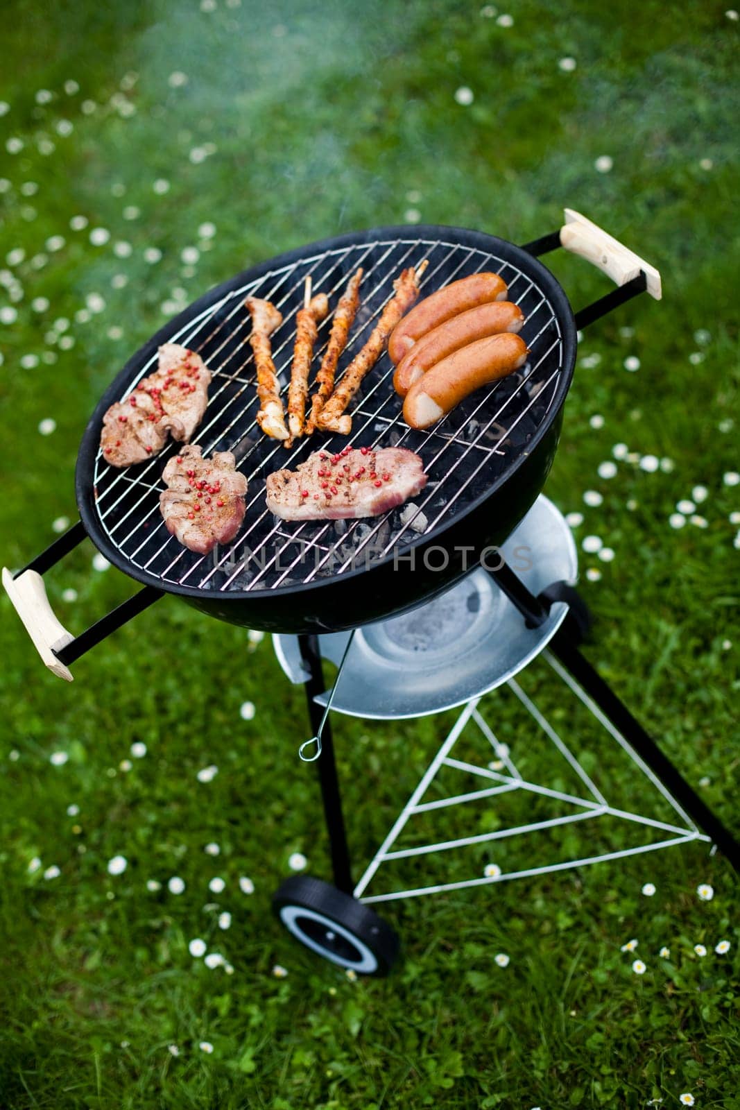 Grilling meat in flames, tasty dinner