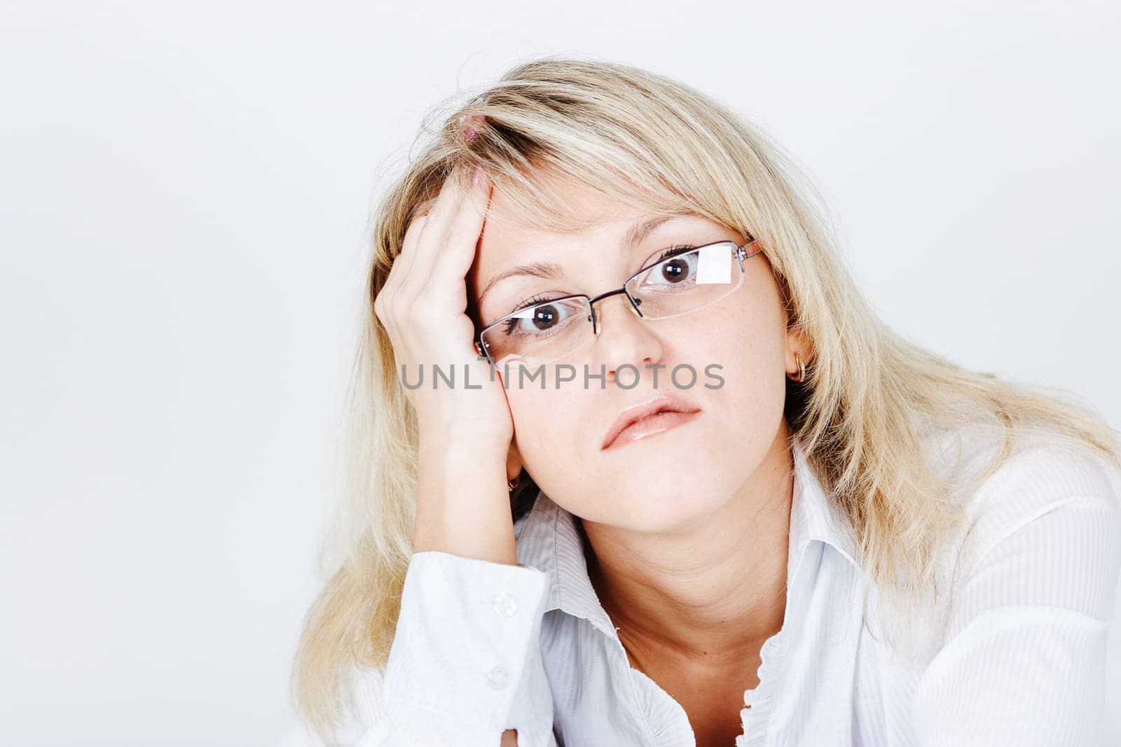 Tired of attractive young blond woman in glasses. portrait