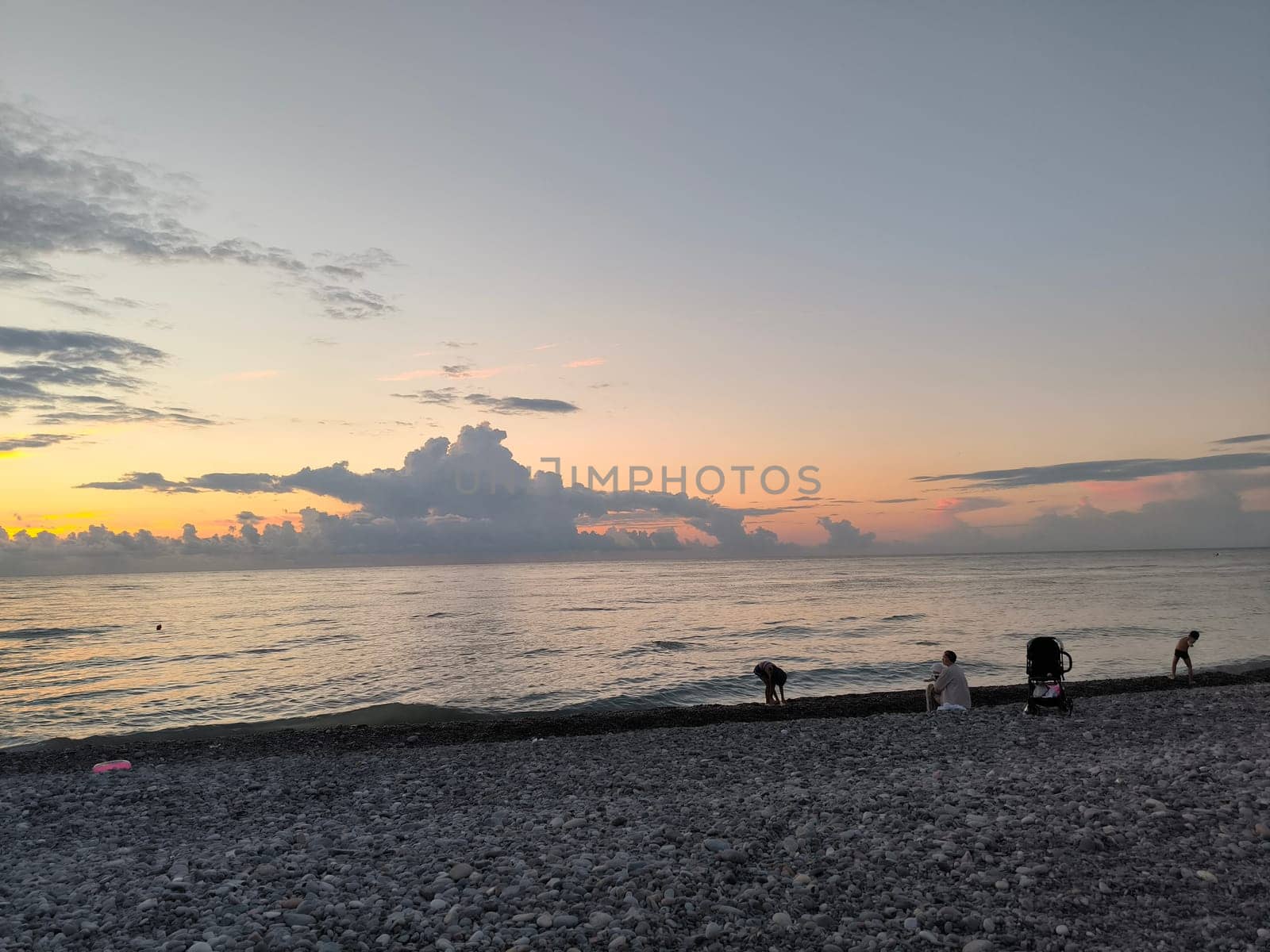 Sea water sunset sky landscape summer Batumi Georgia beach background blue nature orange light wallpaper evening travel people white clouds . High quality photo
