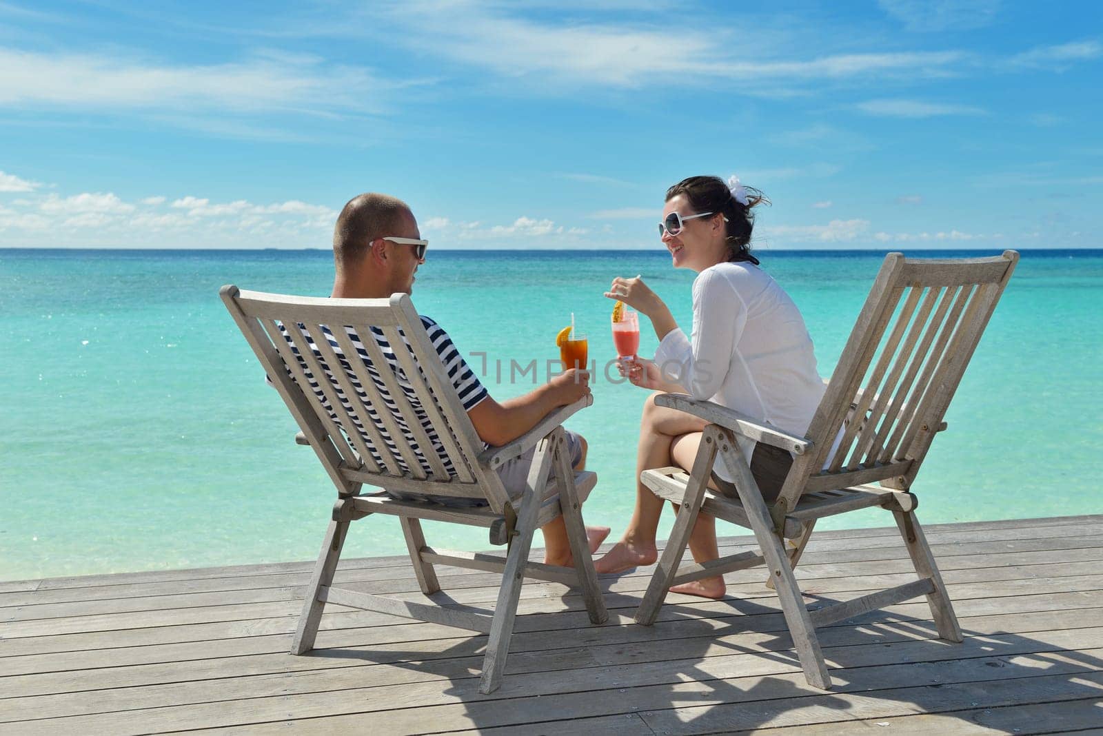 happy young couple relax and take fresh drink at summer vacation