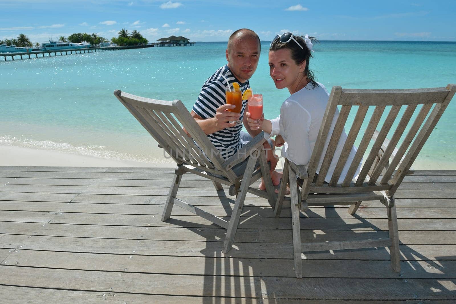 happy young couple relax and take fresh drink at summer vacation