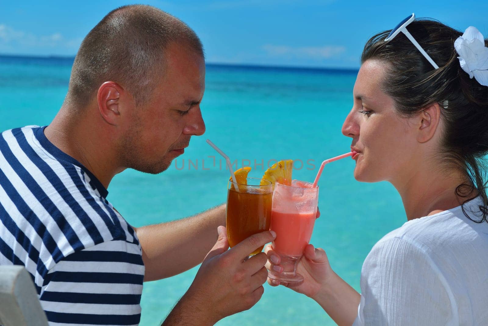happy young couple relax and take fresh drink at summer vacation