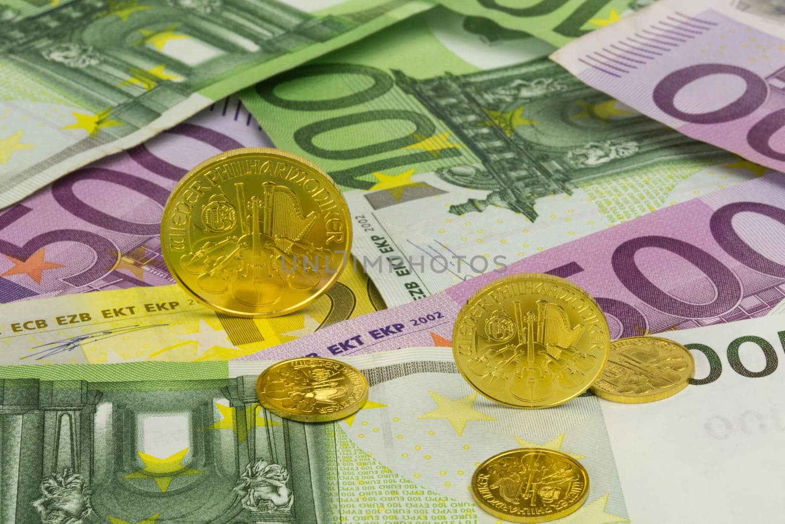 various gold coins on euro banknotes