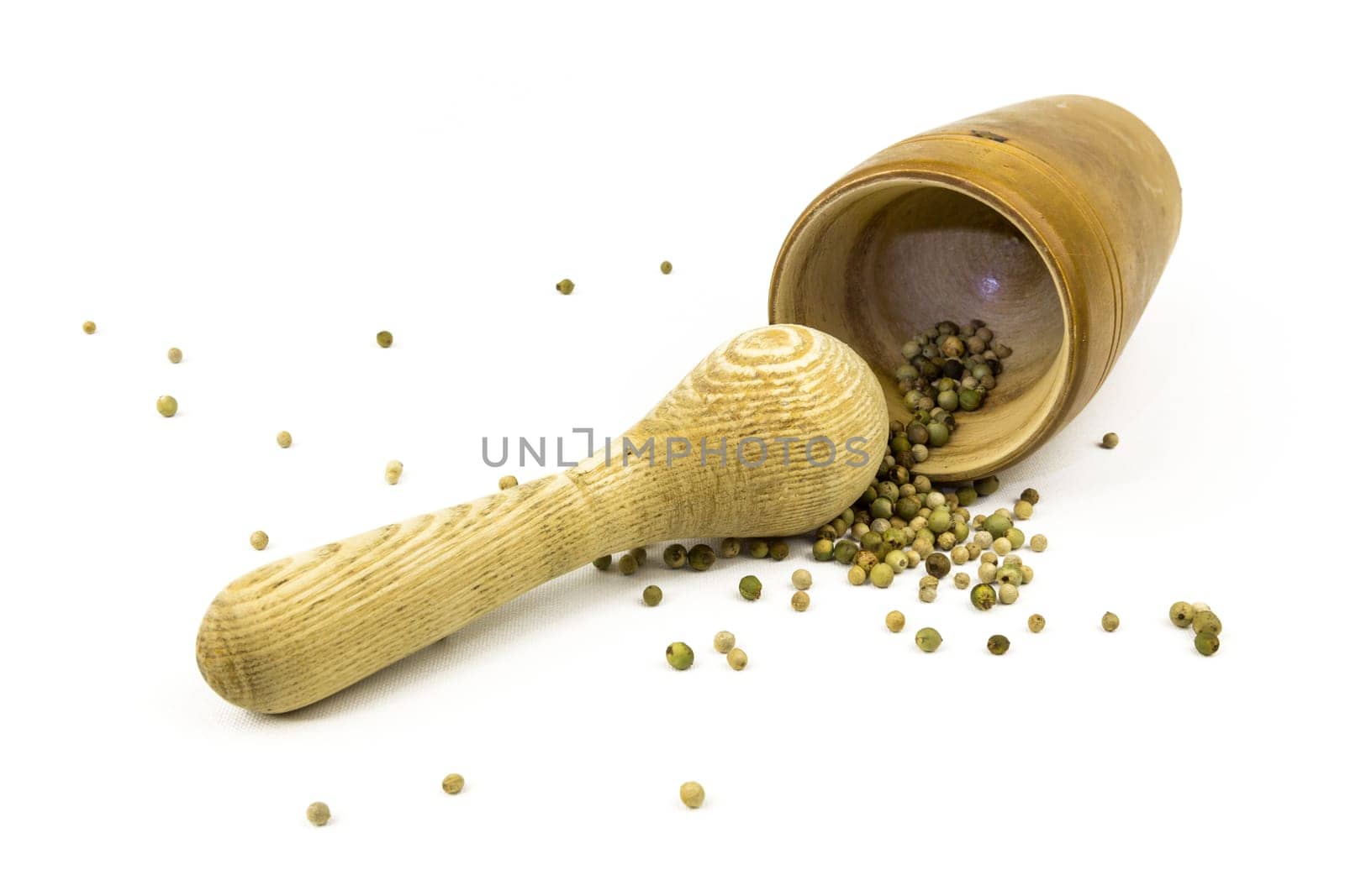Peppercorns in and in front of a lying mortar
