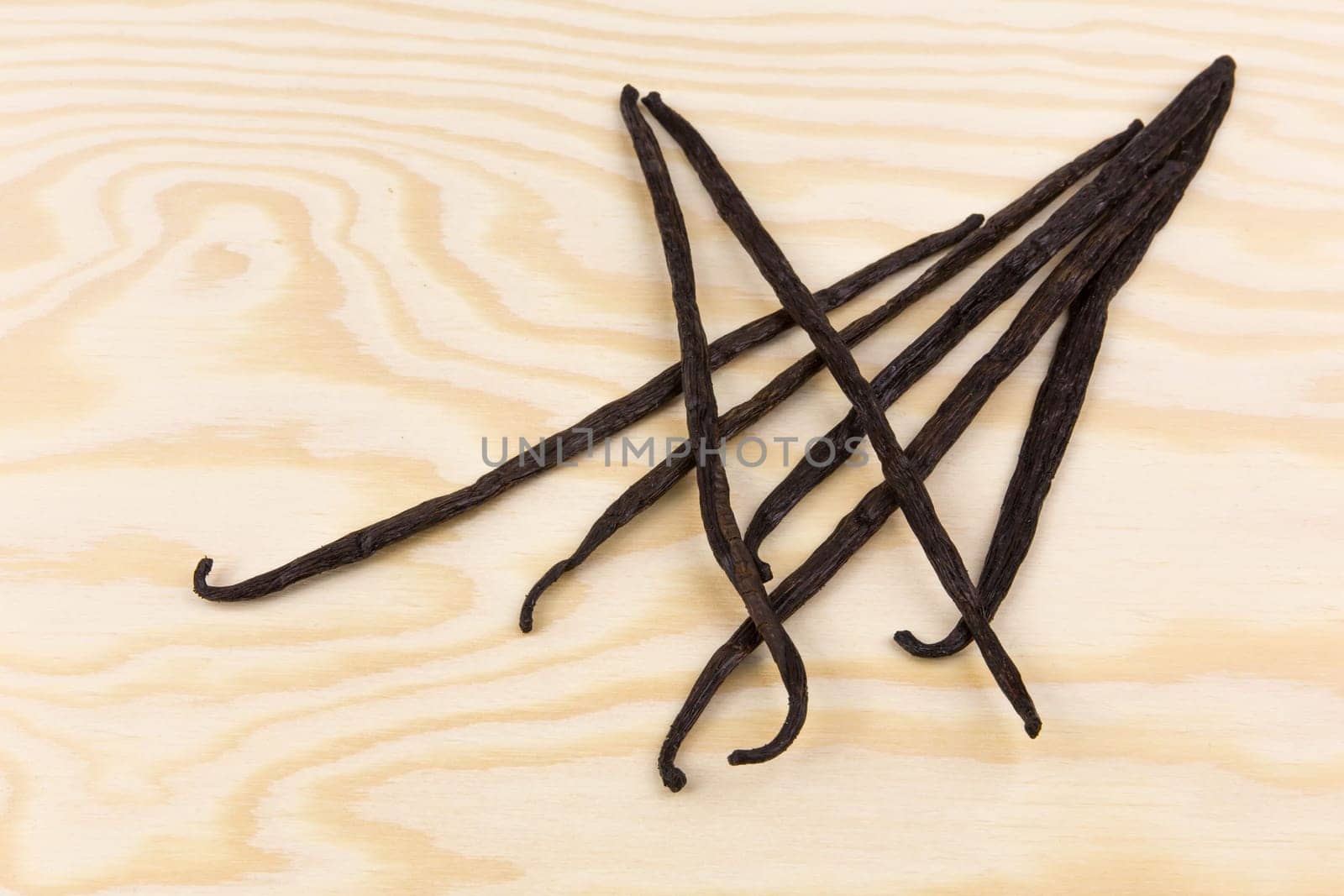 Vanilla pods on a wooden board
