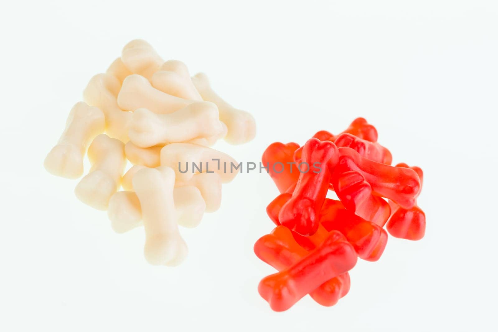 Red and cream gummy bones candy close-up