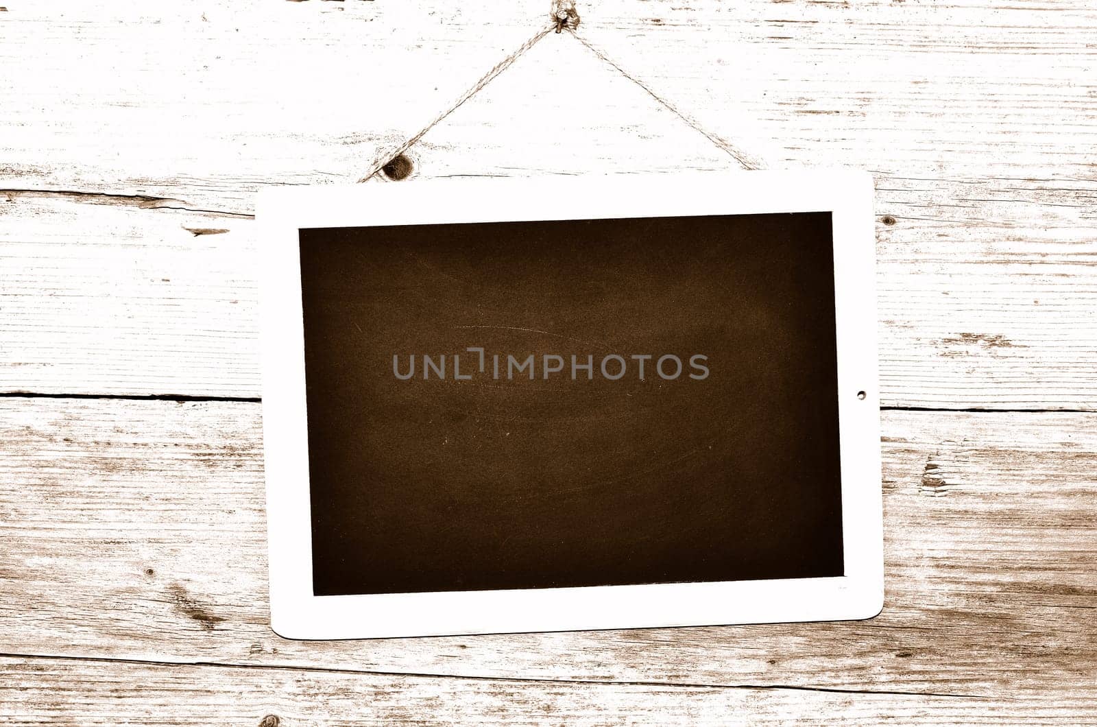 Slate on wooden background