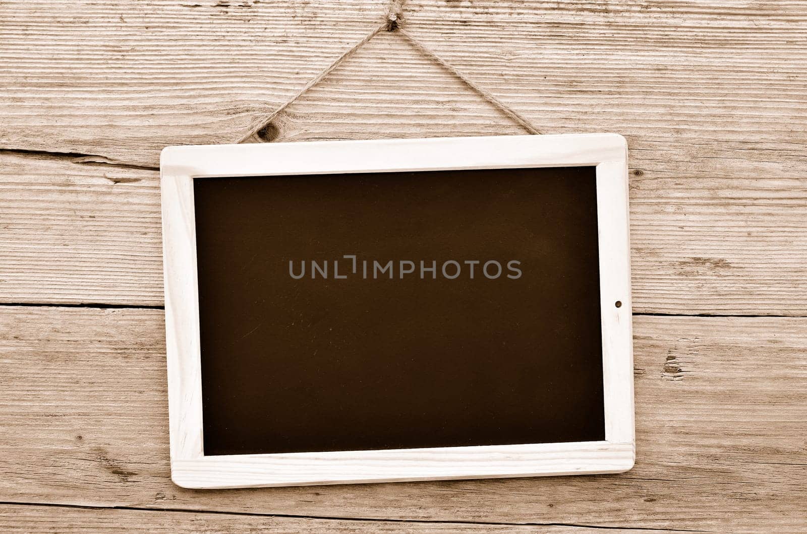 Slate on wooden background