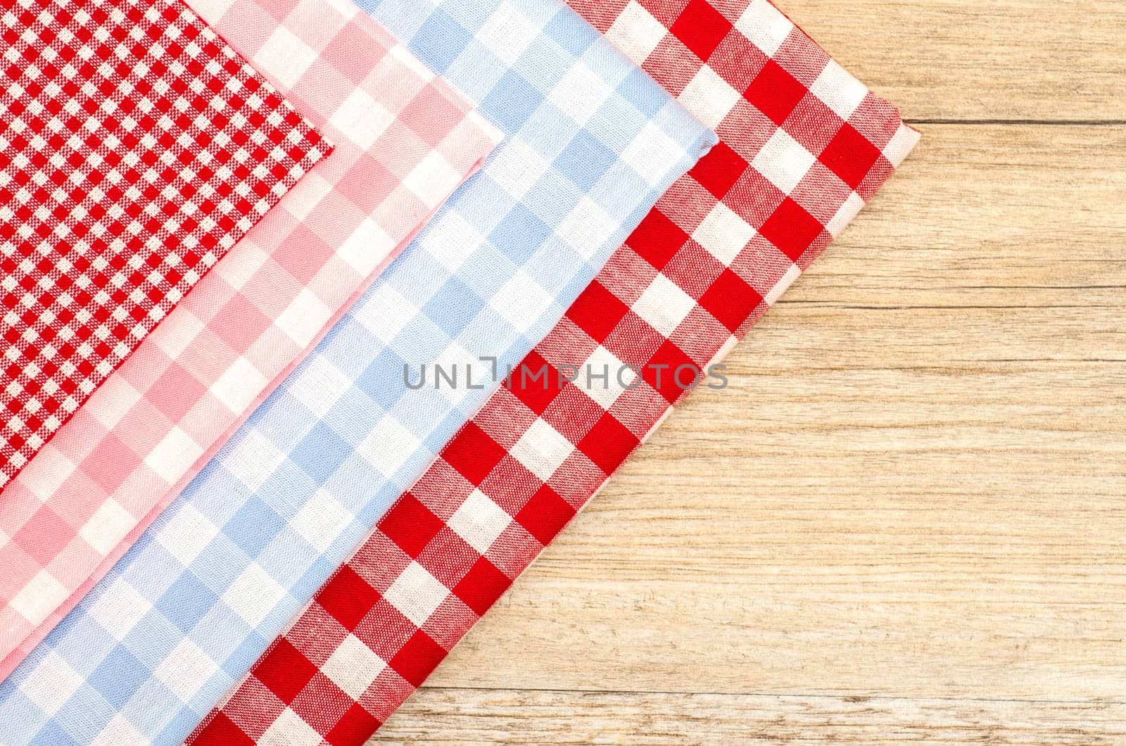 Checkered fabrics and wooden table with text space