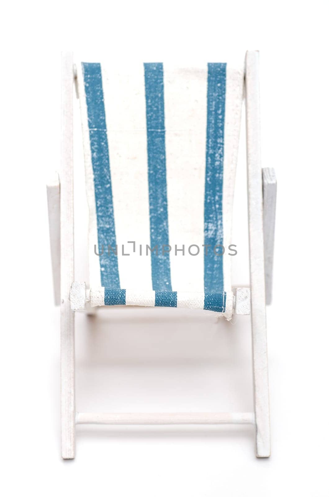 Deckchair with blue and white stripes against a white background