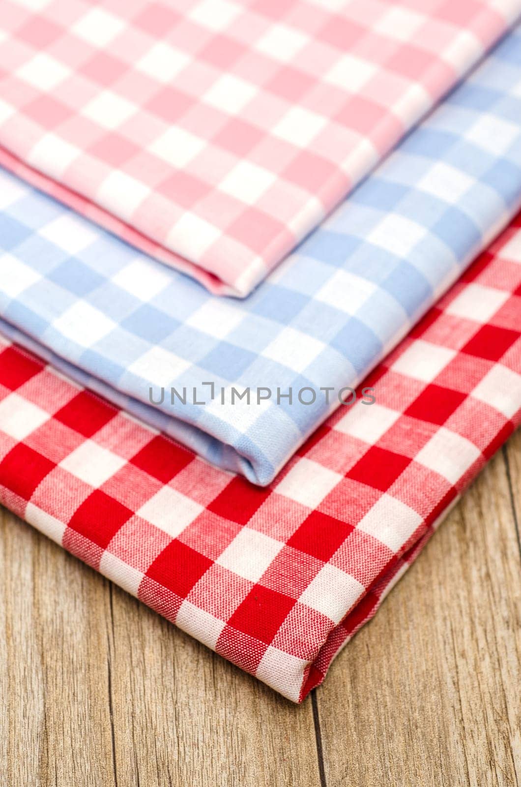 Close-up of checkered fabrics on a wooden table