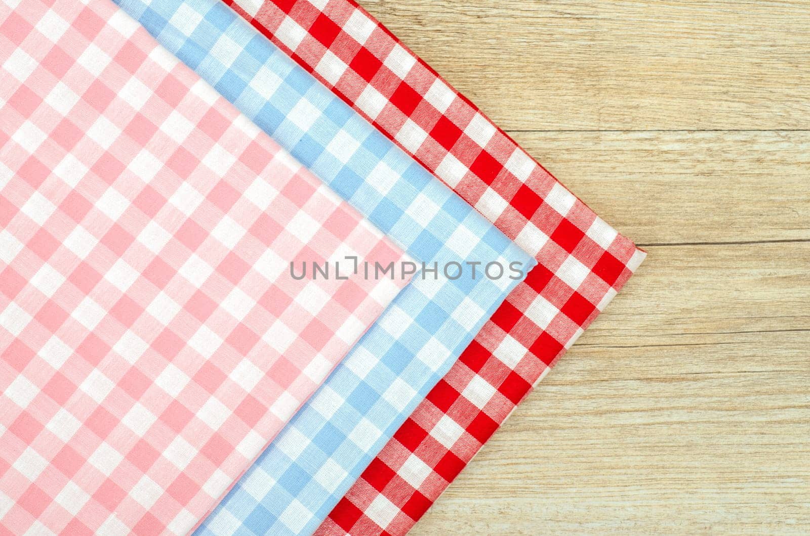 Three fabrics with checks on a wooden table