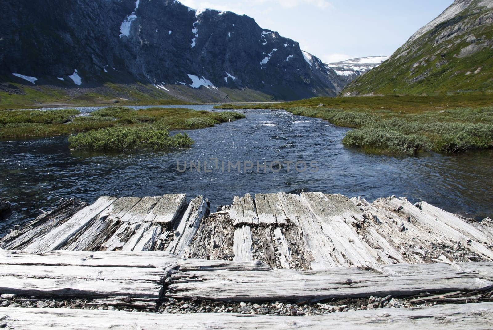 Wooden Planks with Copyspace in a Mountain Landscape above a River