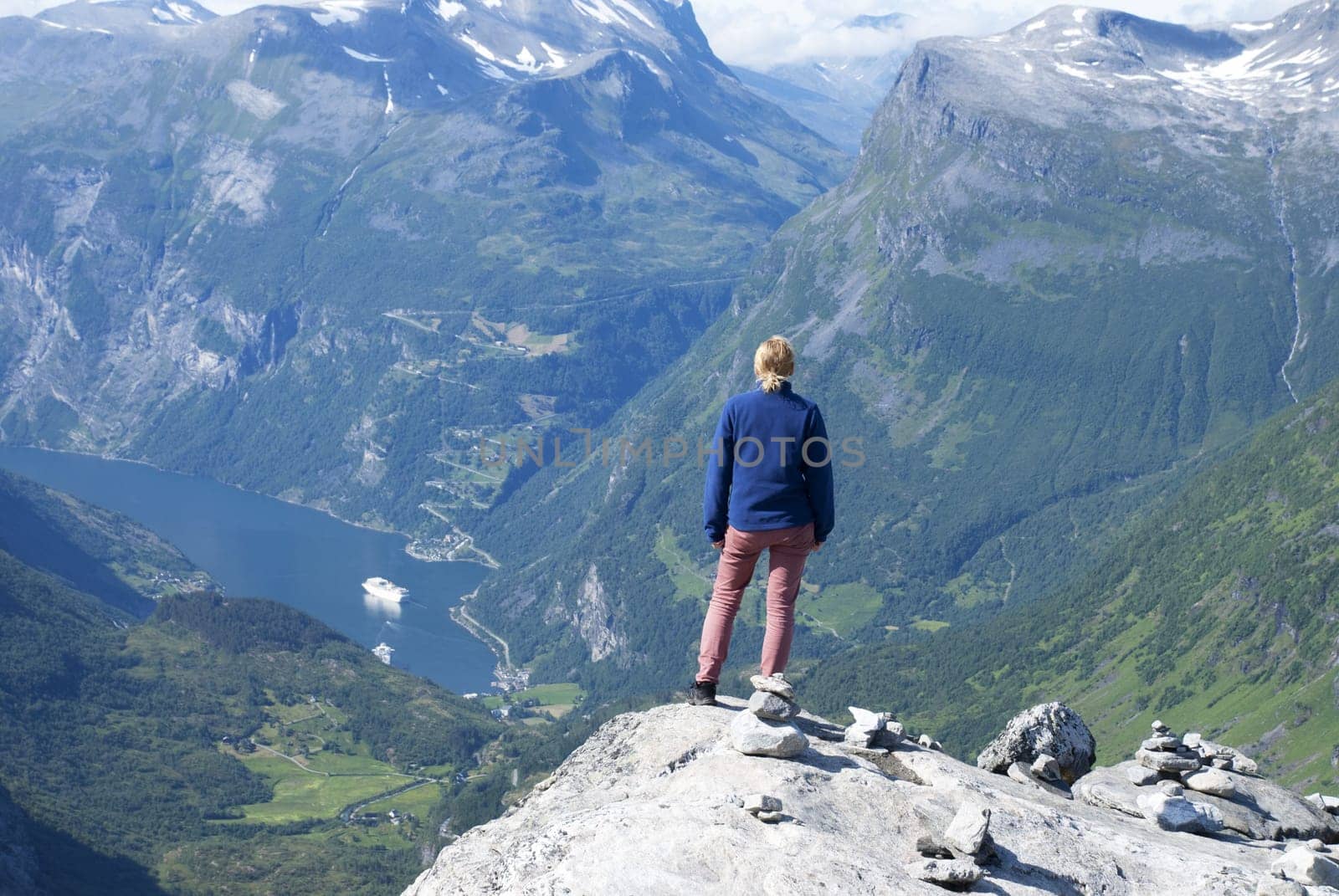 A Woman Enjoying a Panoramatic View Over Geiranger Fjord in Norway