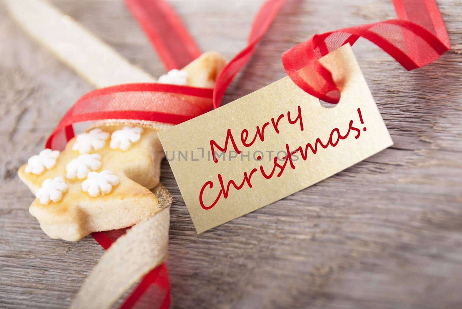 a golden label with a in red written merry christmas on it