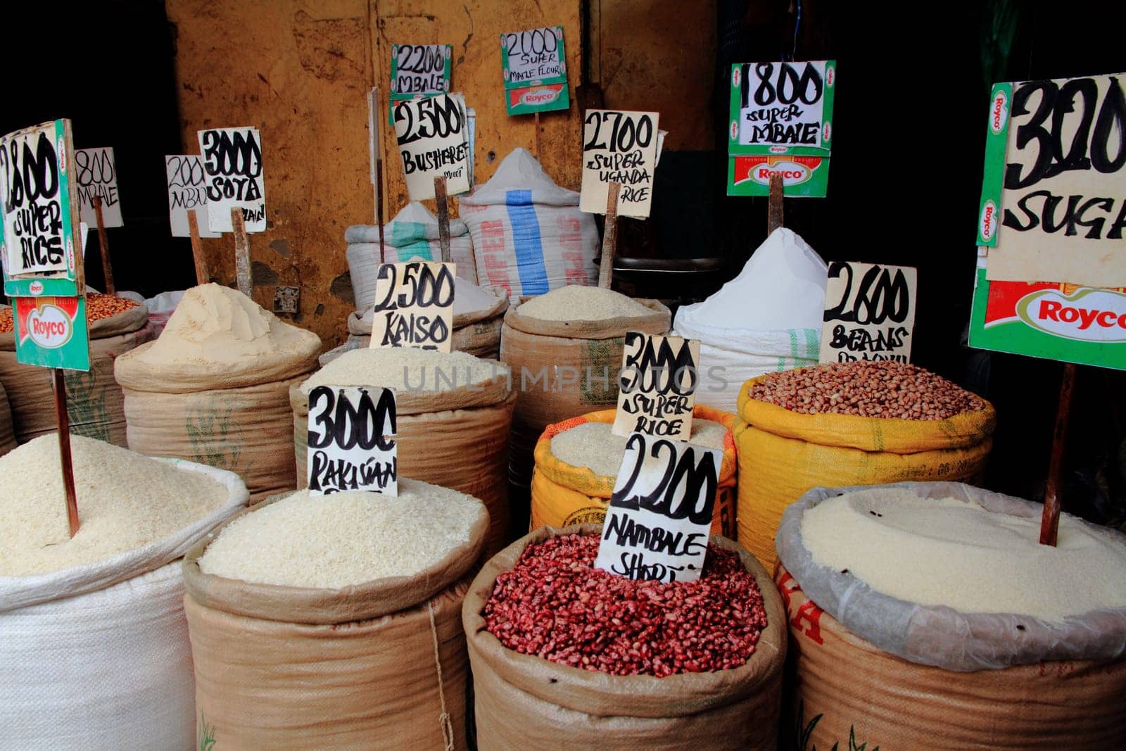 Bags of Rice Beans and Sugar, with prices, in a market in Kampala, Uganda