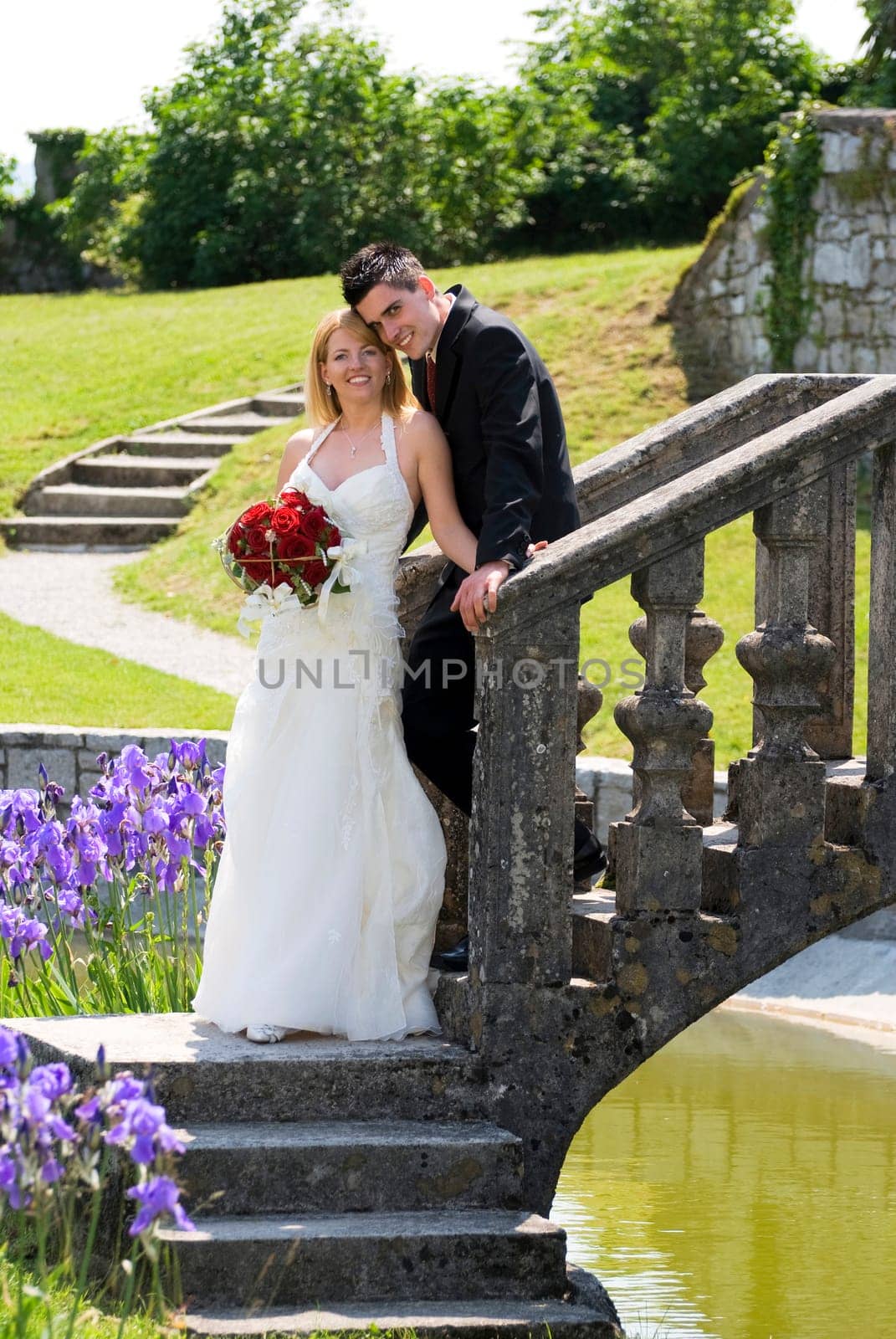 A bride and groom standing outside portrait