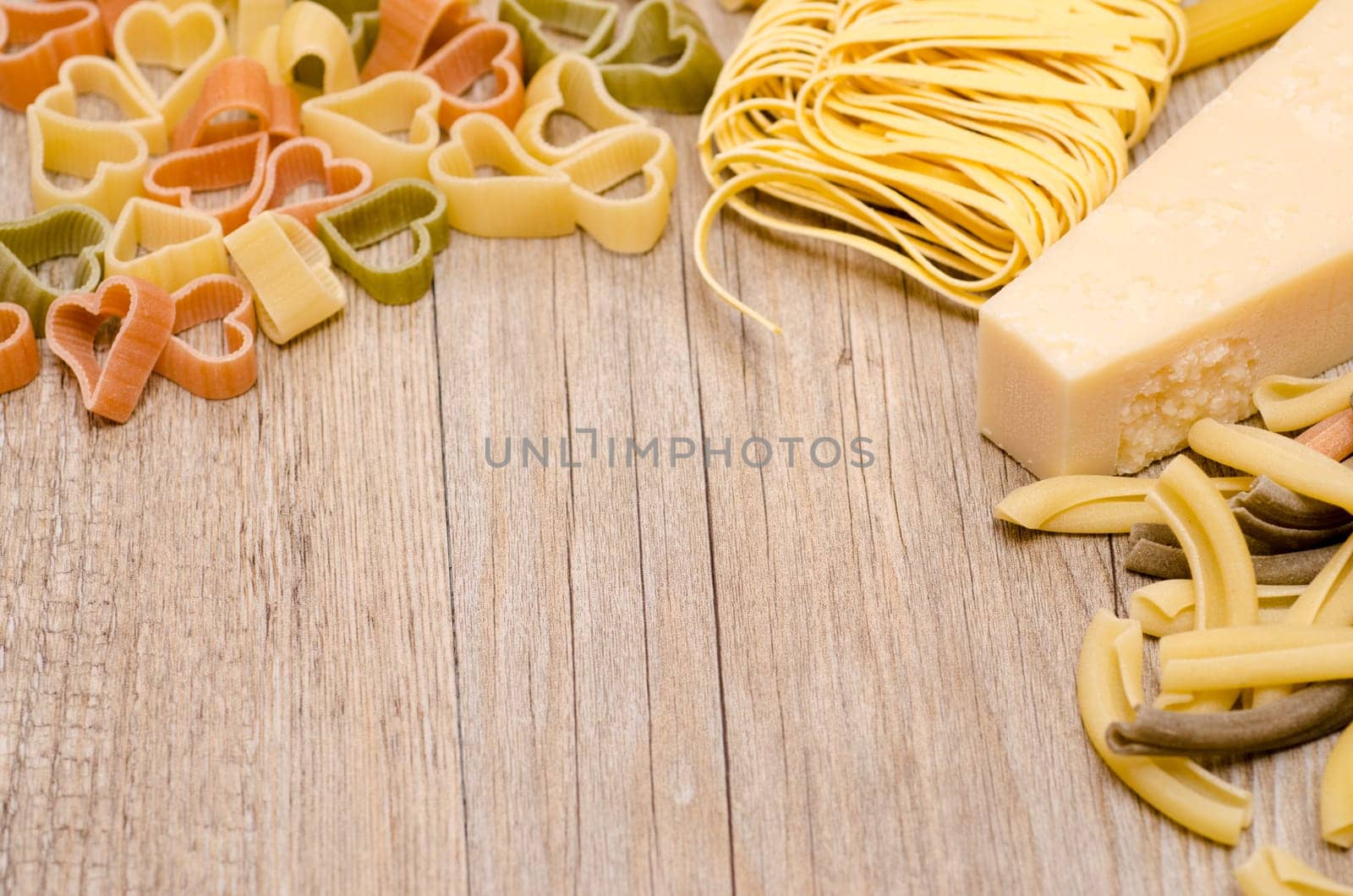 Pasta and Parmesan cheese with free text space for advertising on a wooden board