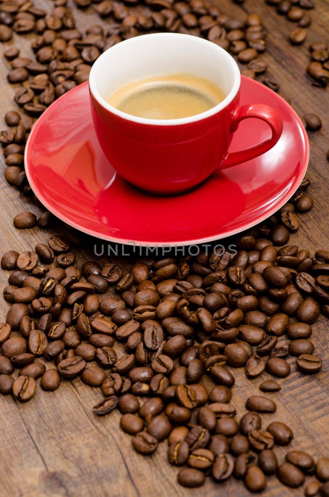 Arabica beans and red espresso cup in portrait format