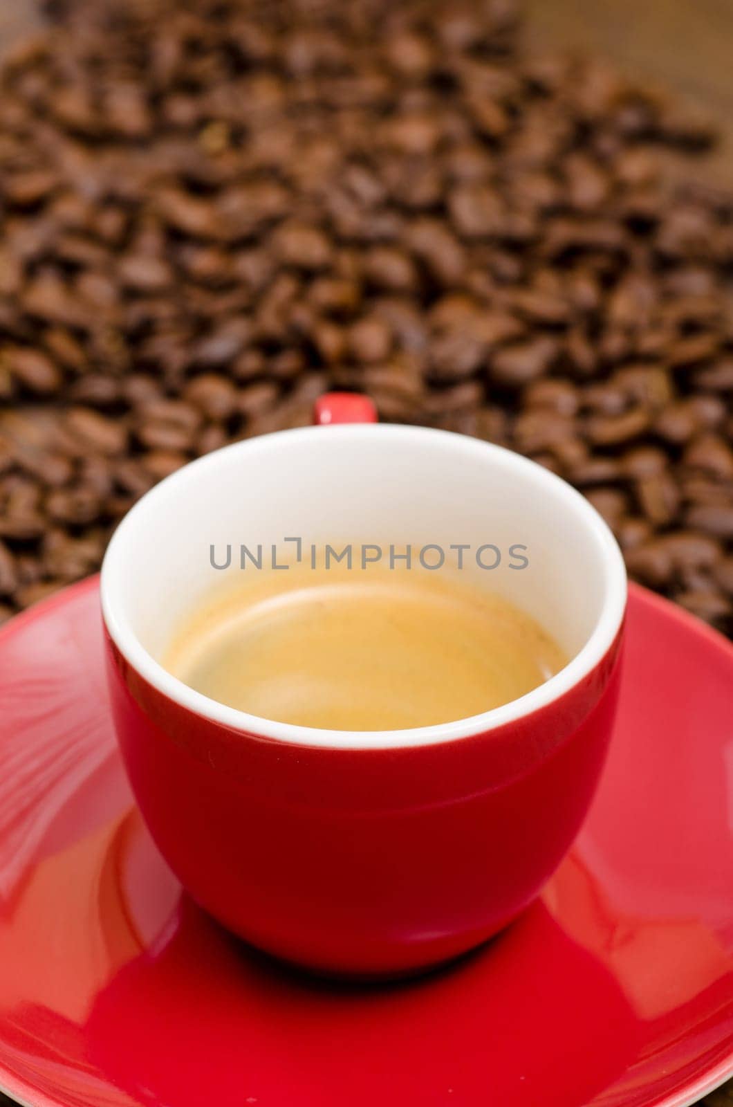 Close-up espresso in red cup and Arabica beans