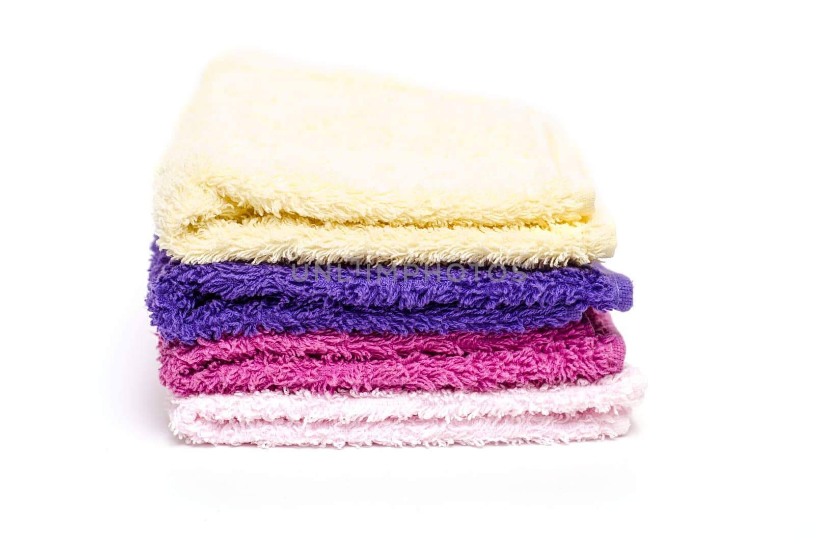 Different coloured washcloths on a white background