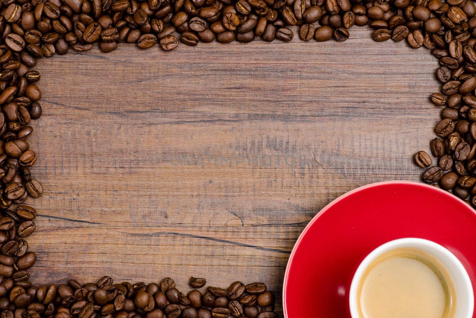 Coffee beans as a frame with red cup and text space