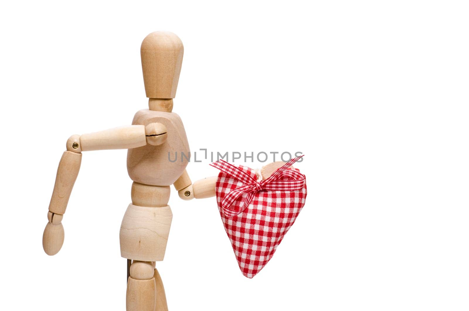 Male figure made of wood holds a red checkered heart