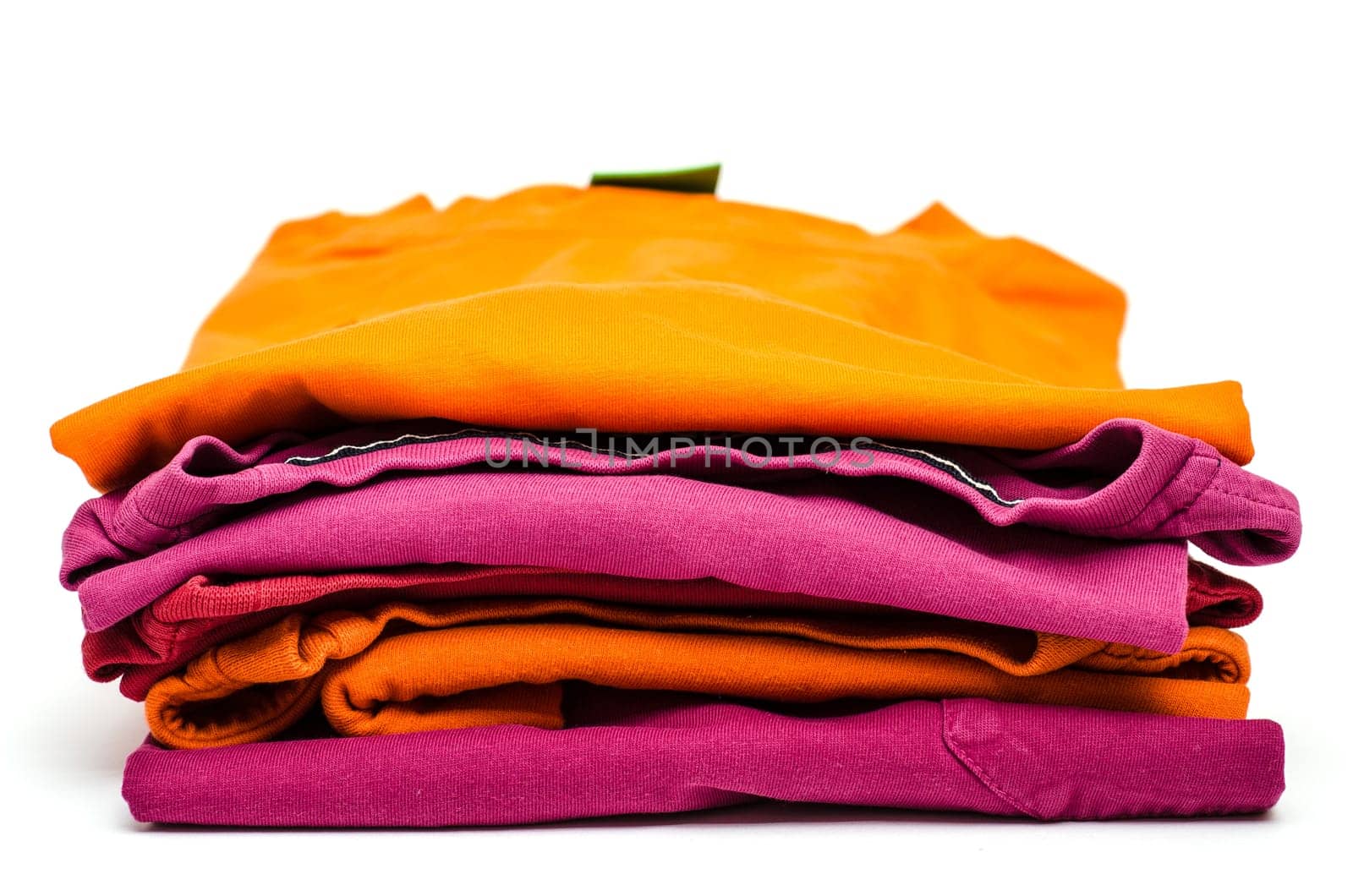 Stack of colored clothes against a white background