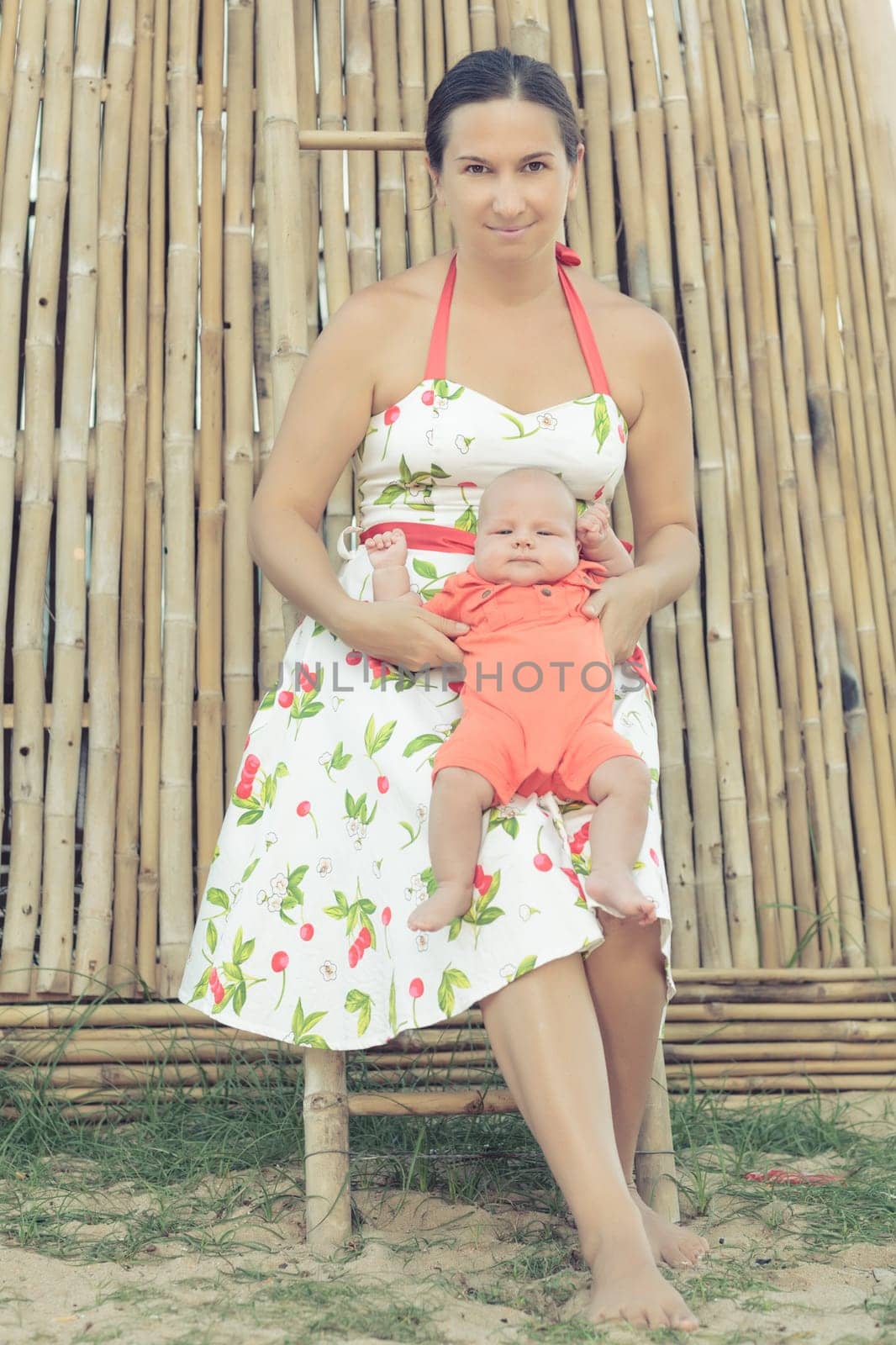 Baby and mom are sitting outdoor