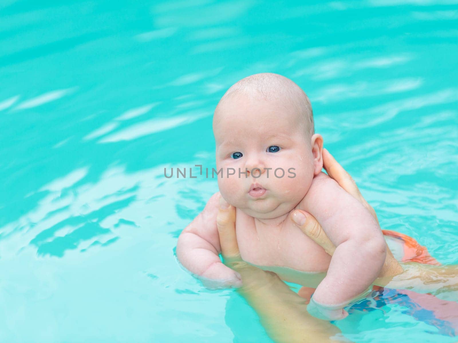 Adorable baby in swimming pool