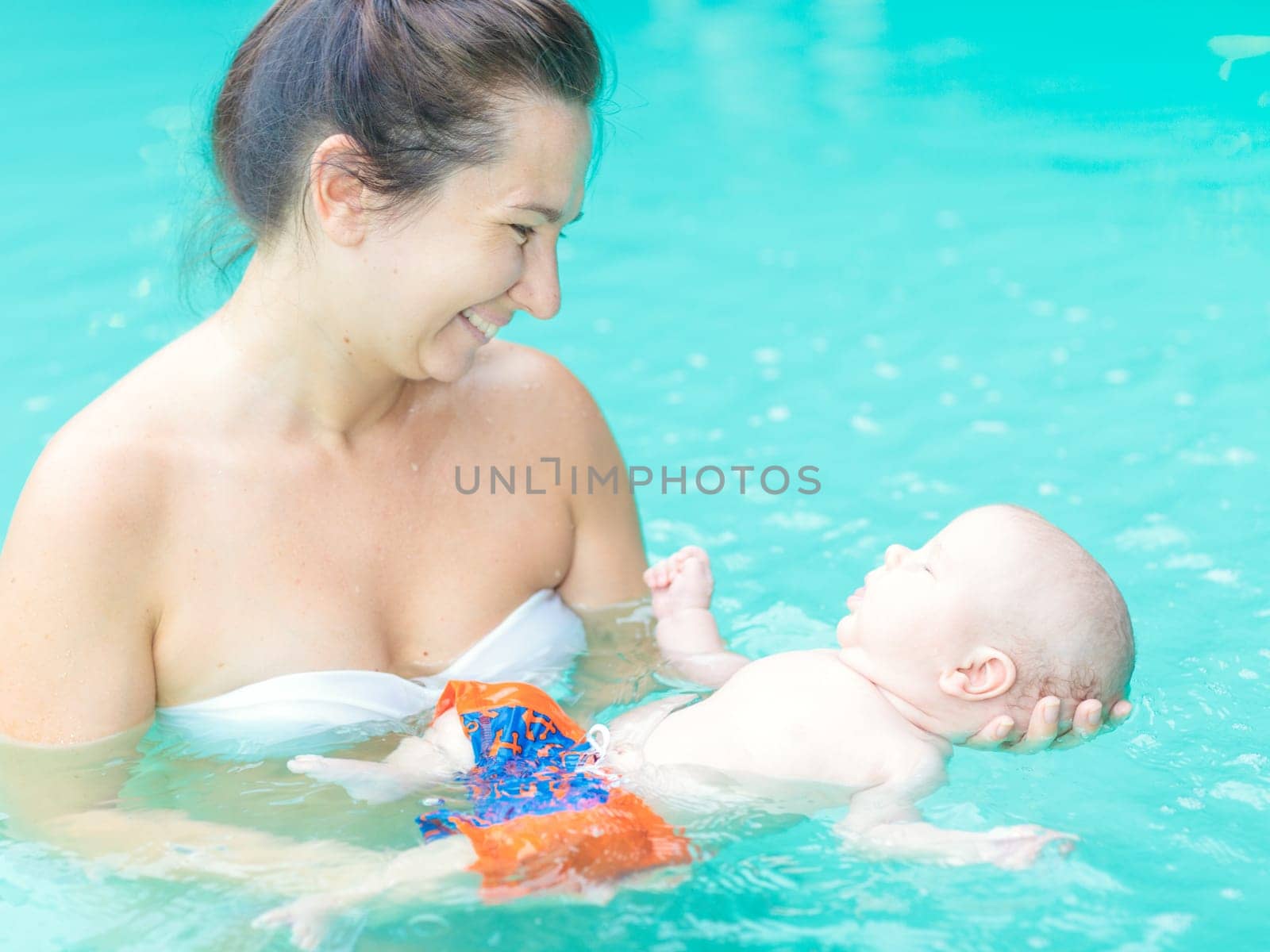 Baby and mom in swimming pool