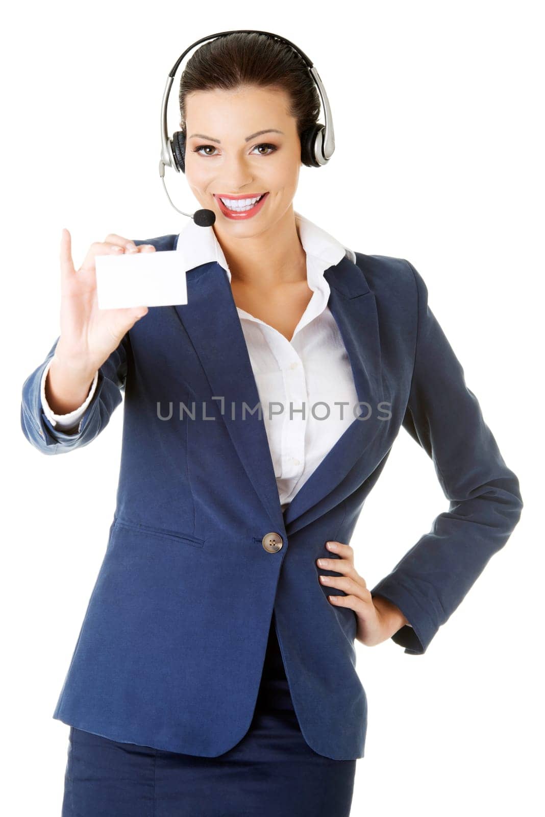 Smiling customer service representative with headset holding a blank empty businesscard. Isolated on white background.