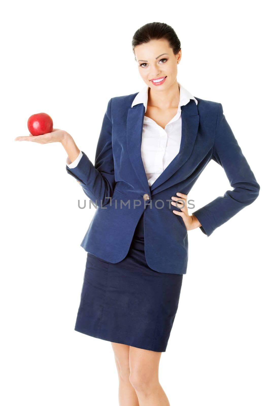 Attractive smiling businesswoman holding red apple, isolated on white