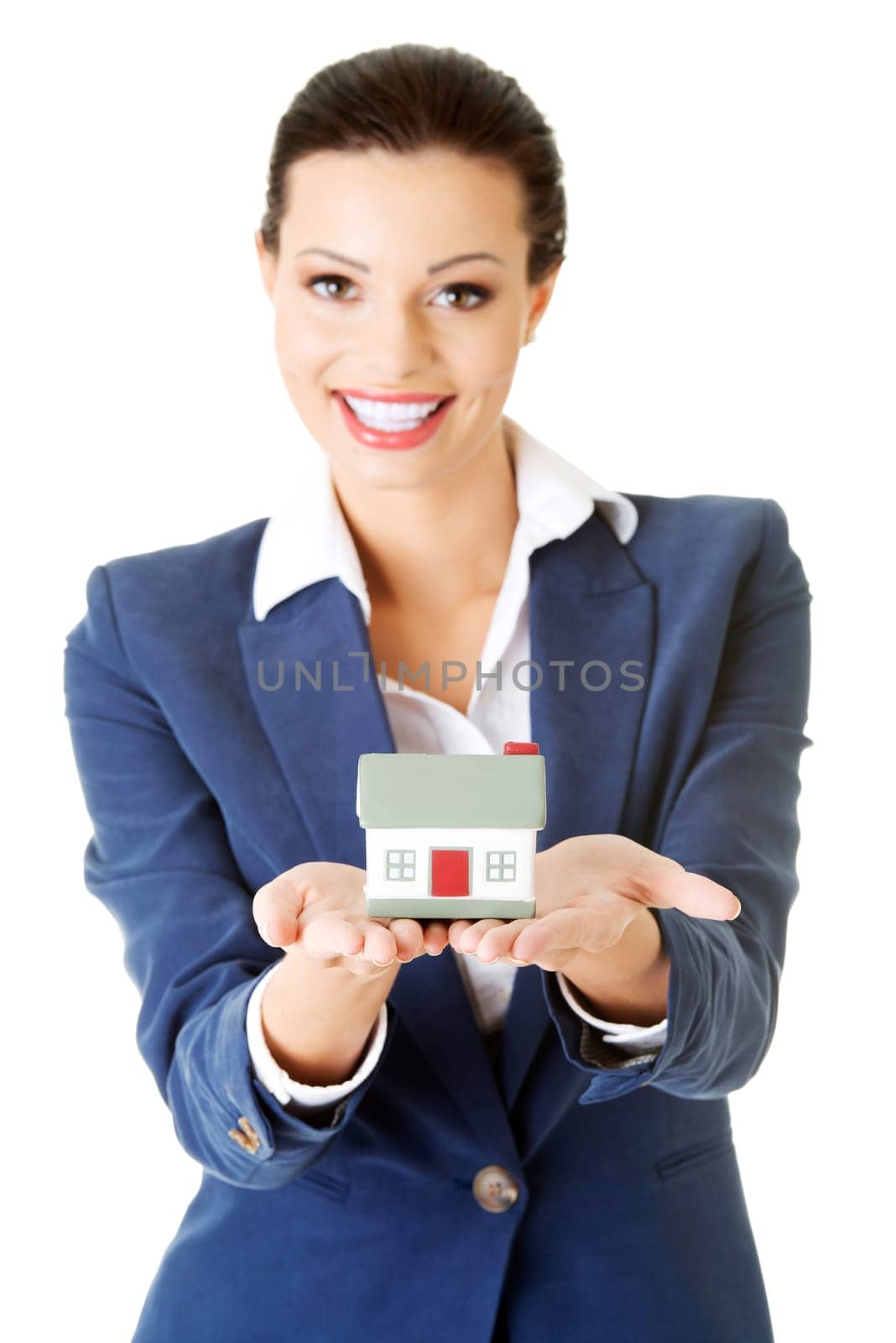 Beautiful young businesswoman holding house model over white - real estate loan concept